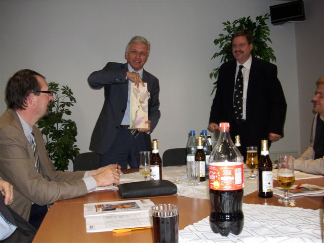 Hannes Markert schenkt Manfred Kolbe (v.r.n.l.) eine Flasche sächsischen Weines.